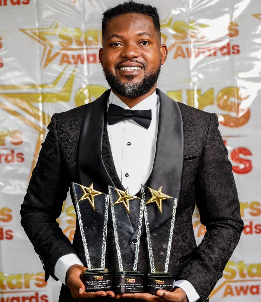 Sparqlyn smiling with trophies